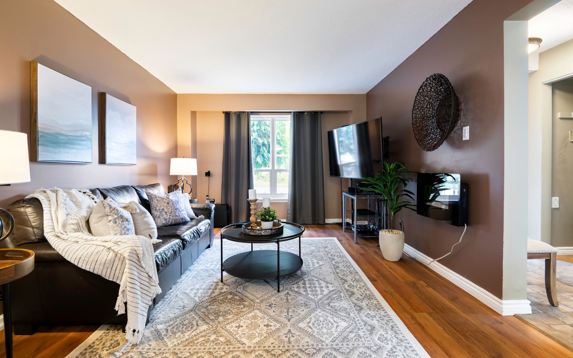A living room with a couch , coffee table , and television.