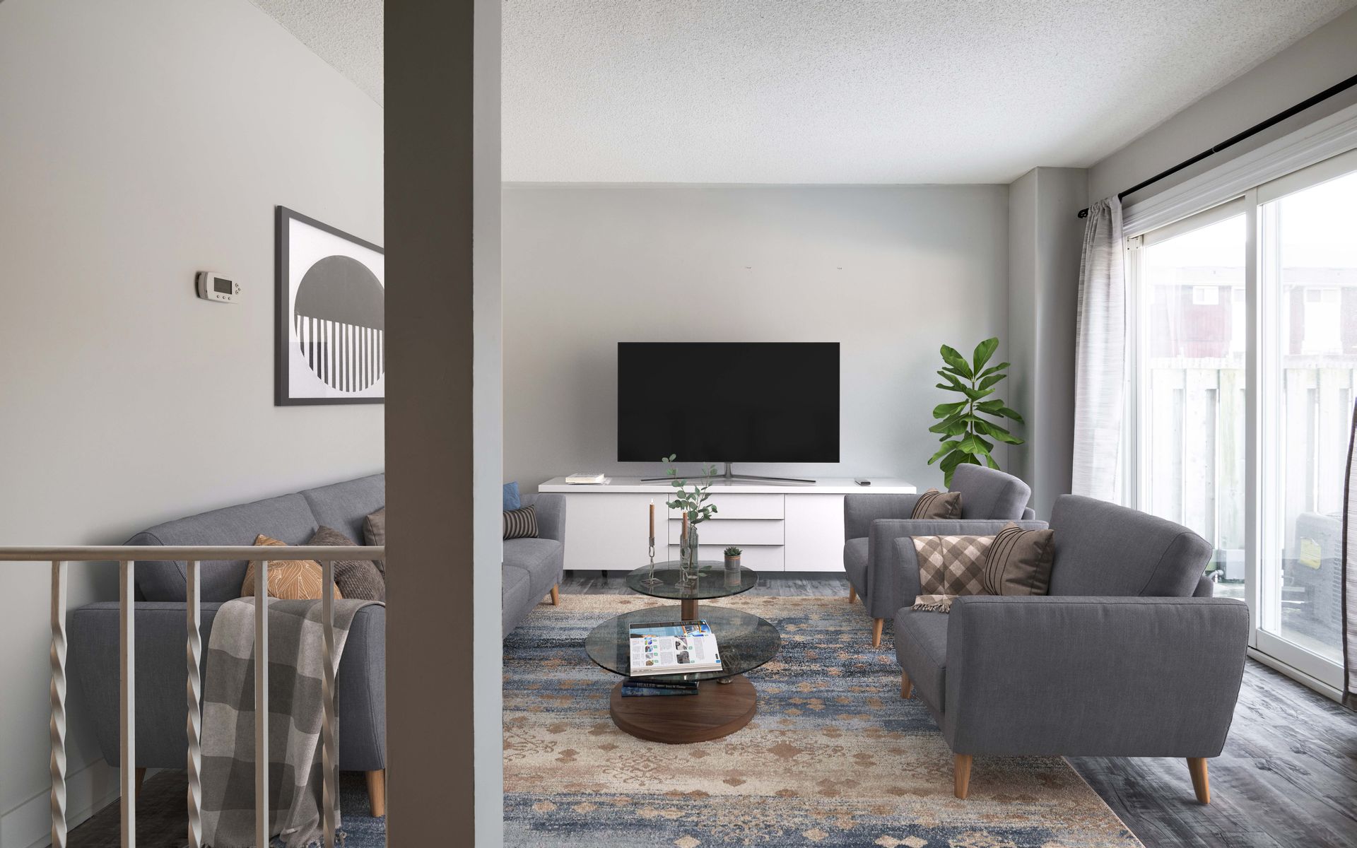 A living room with a couch , chairs , and a flat screen tv.