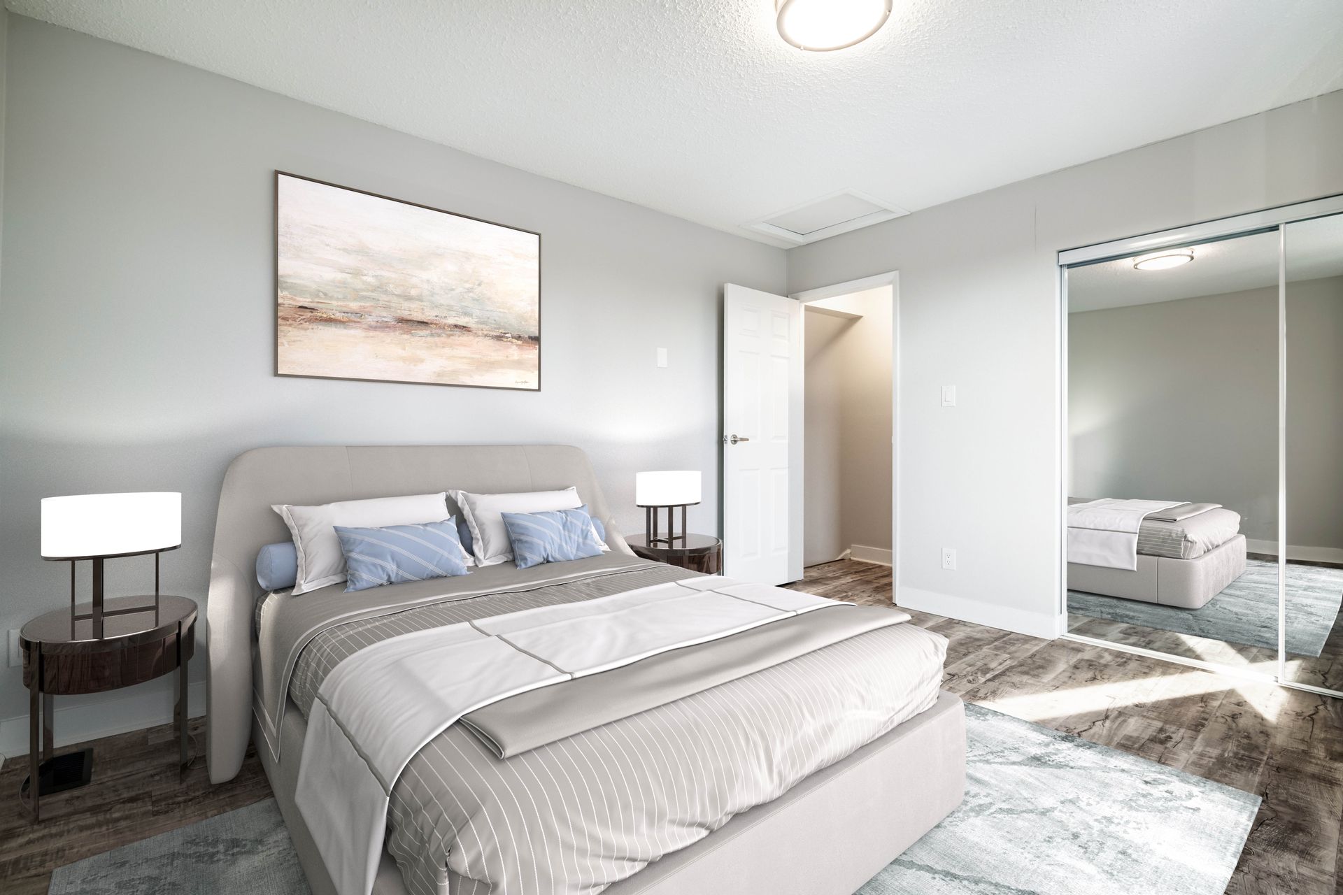 A bedroom with a large bed and a walk in closet.