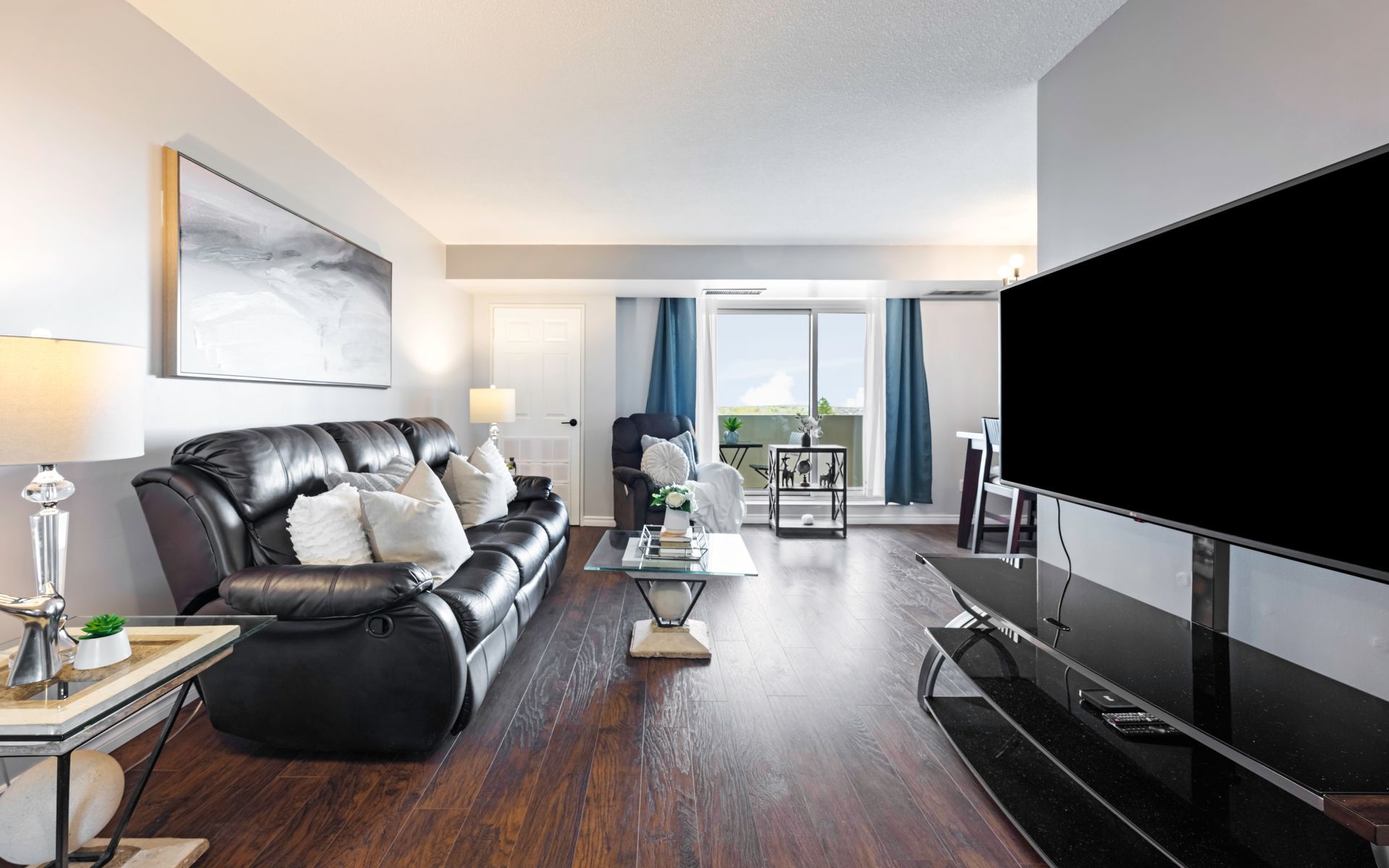 A living room with a couch and a flat screen tv.