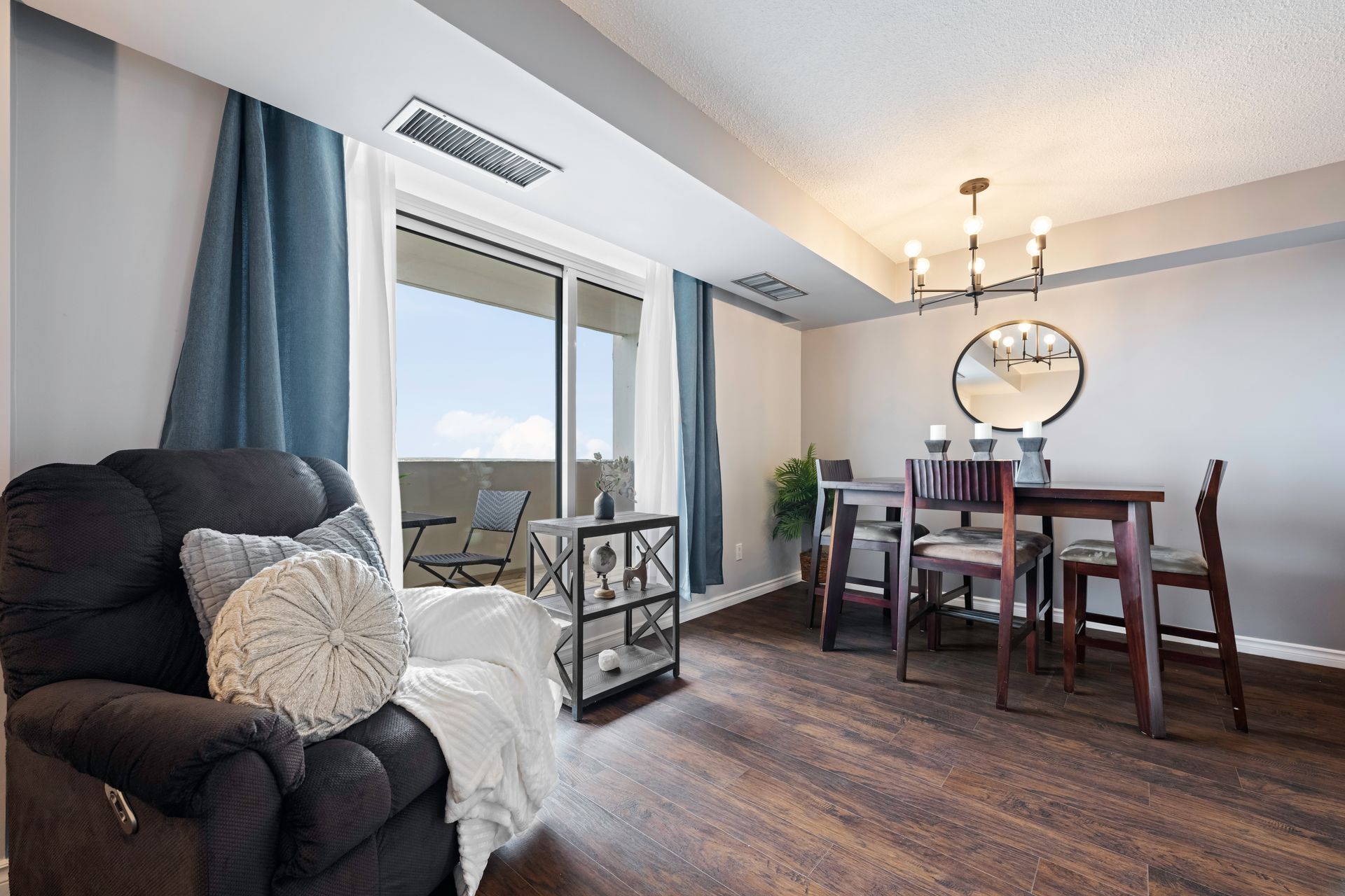 A living room with a recliner , dining table and chairs.