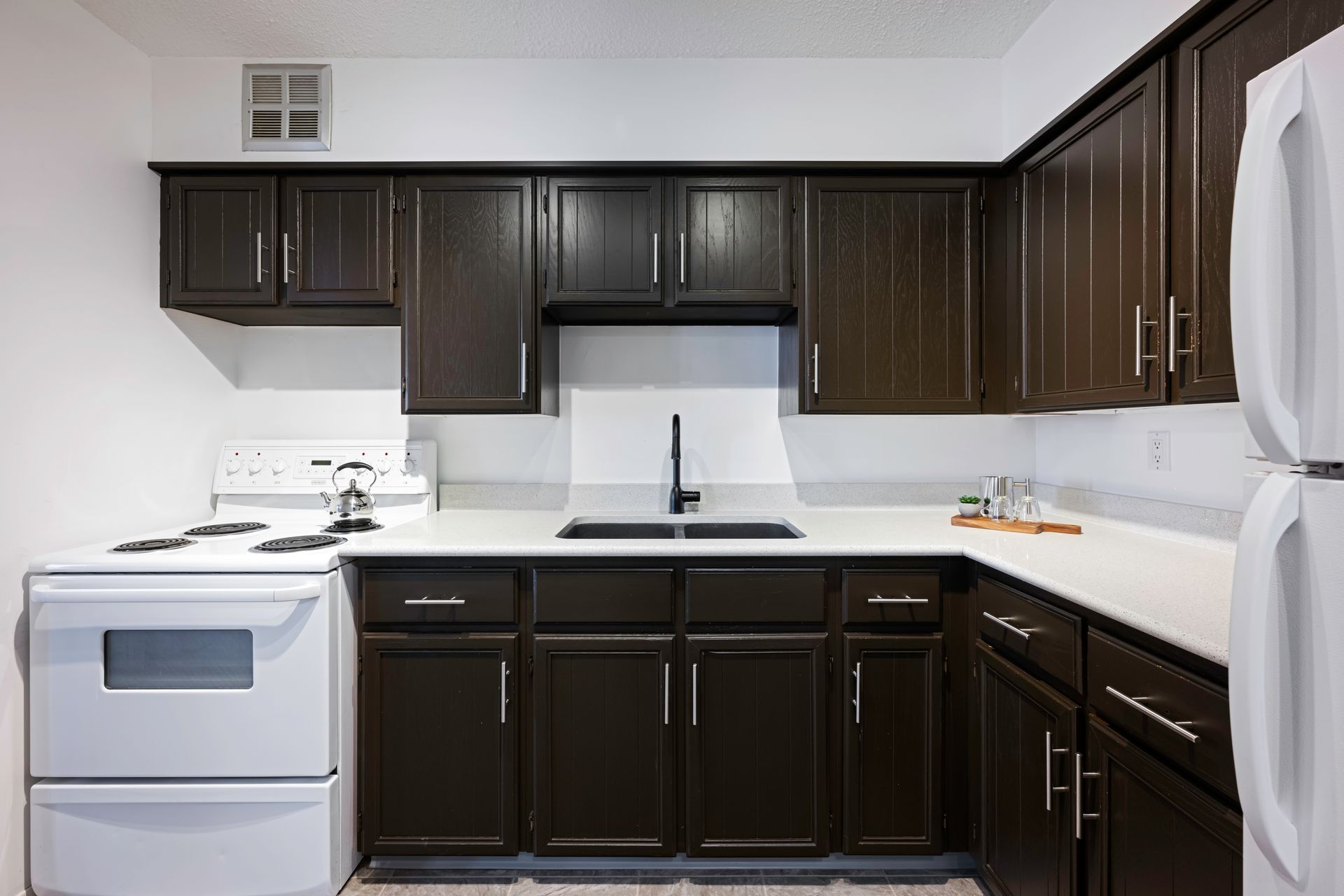 A kitchen with brown cabinets and white appliances