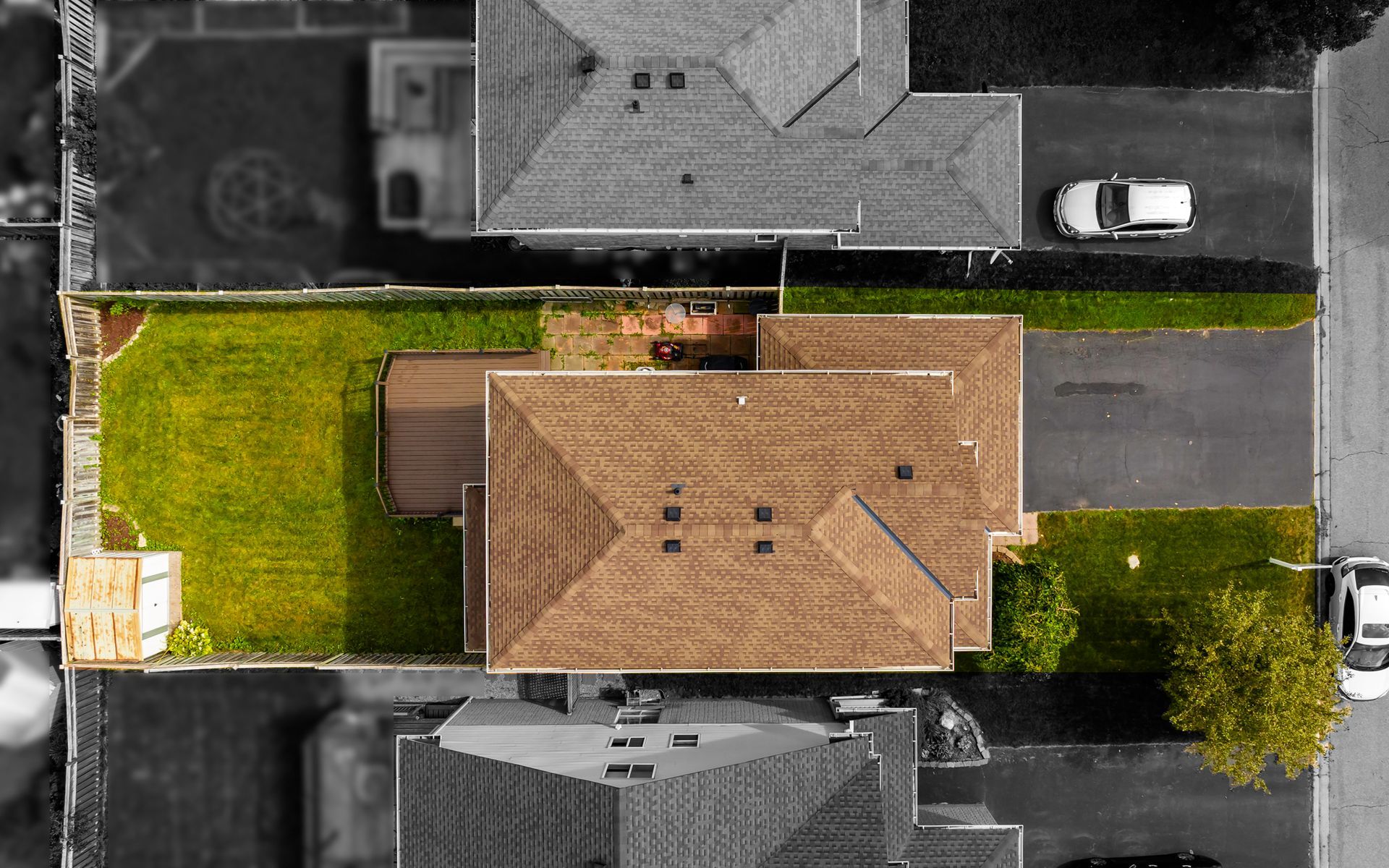 An aerial view of a house with a car parked in front of it.
