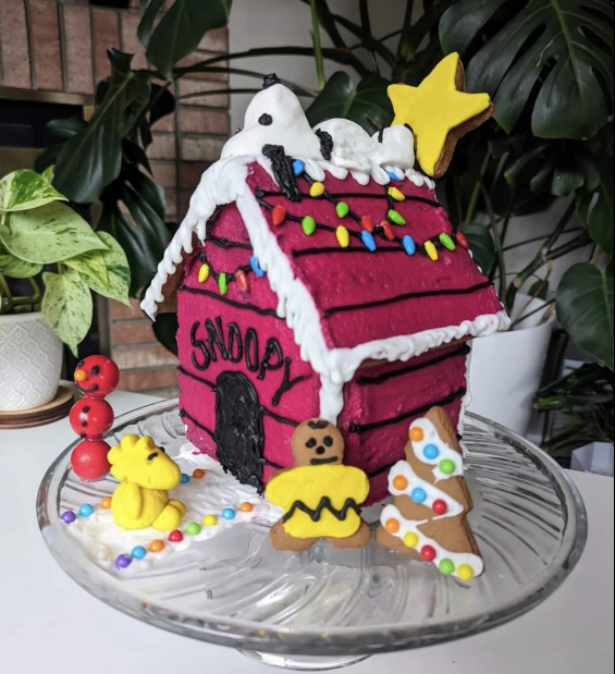 A gingerbread house with the word snoopy on it