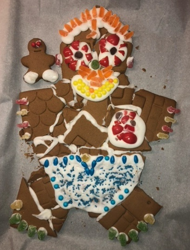 A gingerbread man is sitting on a piece of wax paper