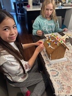 Little girl with a gingerbreadman house