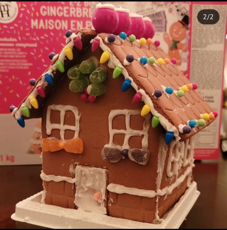 A gingerbread house with a bow on the door