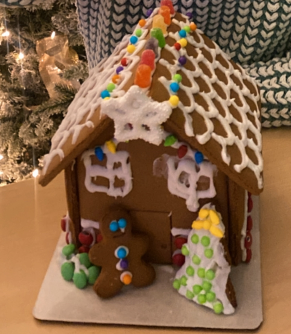 A gingerbread house with a gingerbread man and a christmas tree