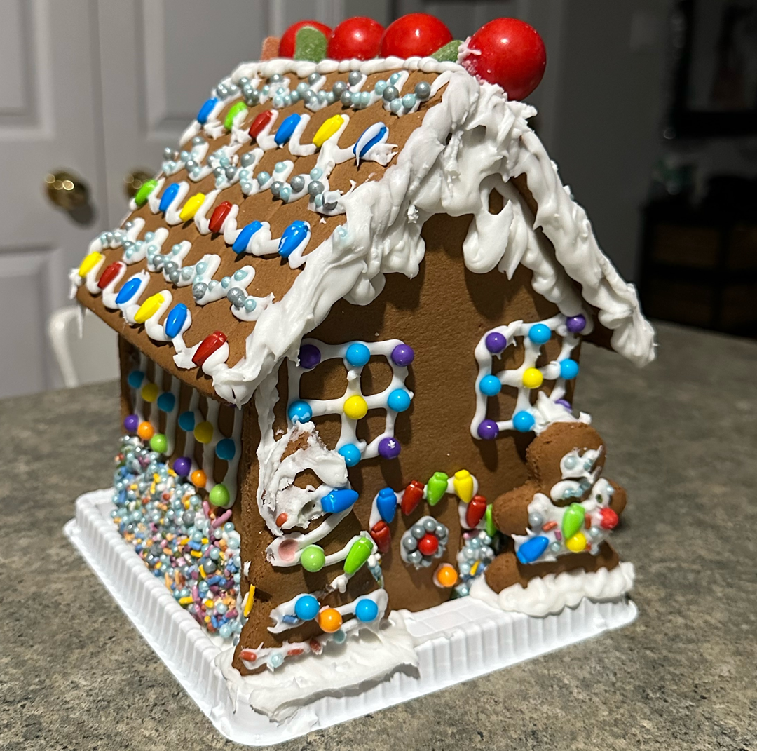 A gingerbread house decorated with icing and sprinkles