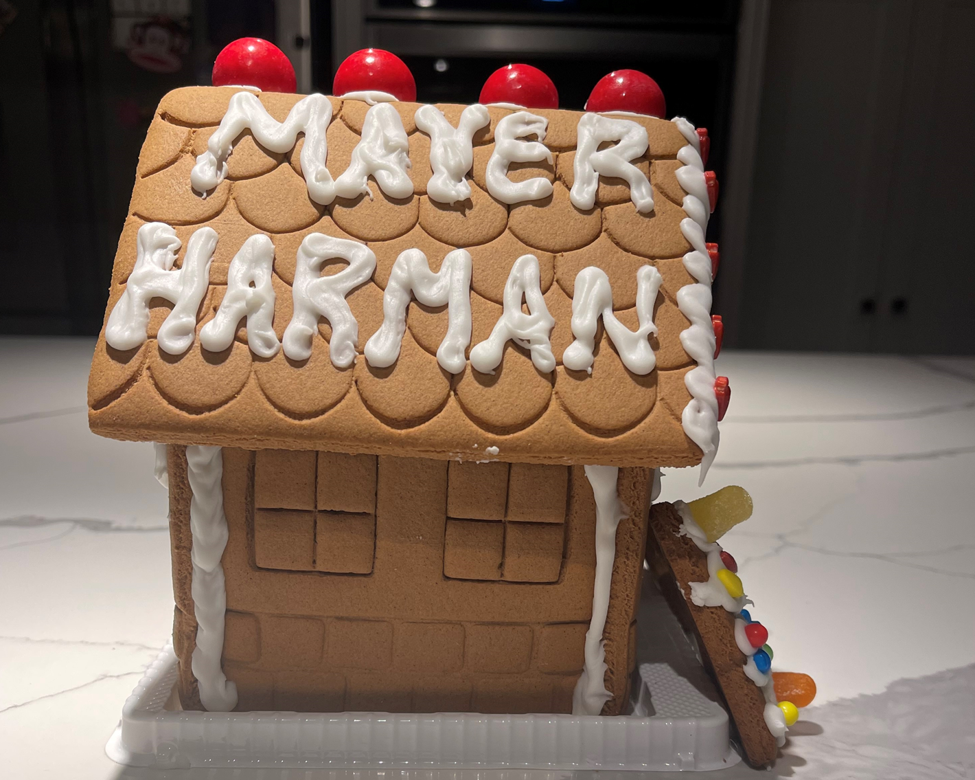 A gingerbread house with the name mayer harman on it