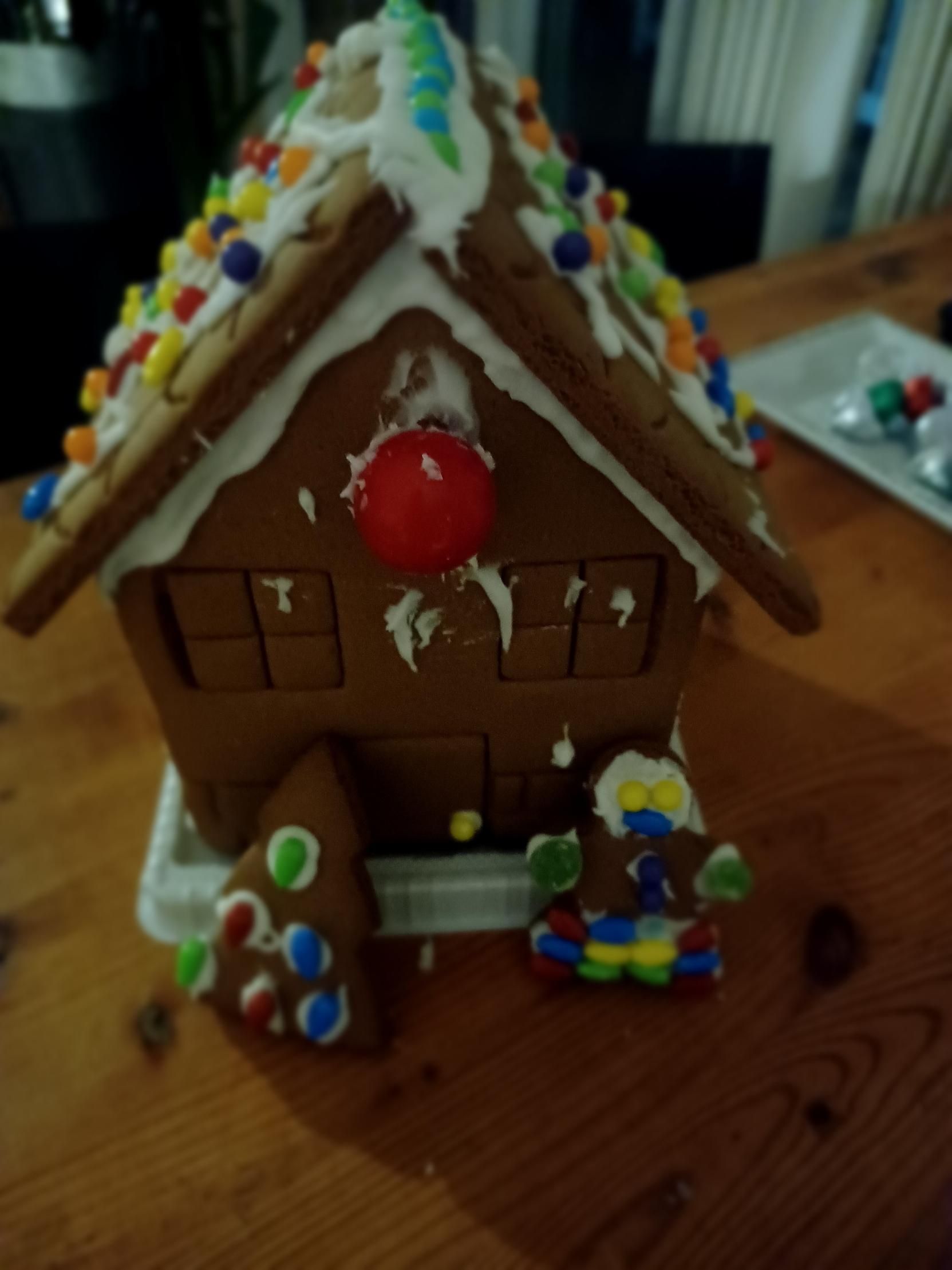 A gingerbread house sitting on a wooden table