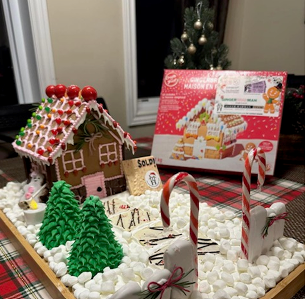 A gingerbread house sitting on top of a pile of marshmallows