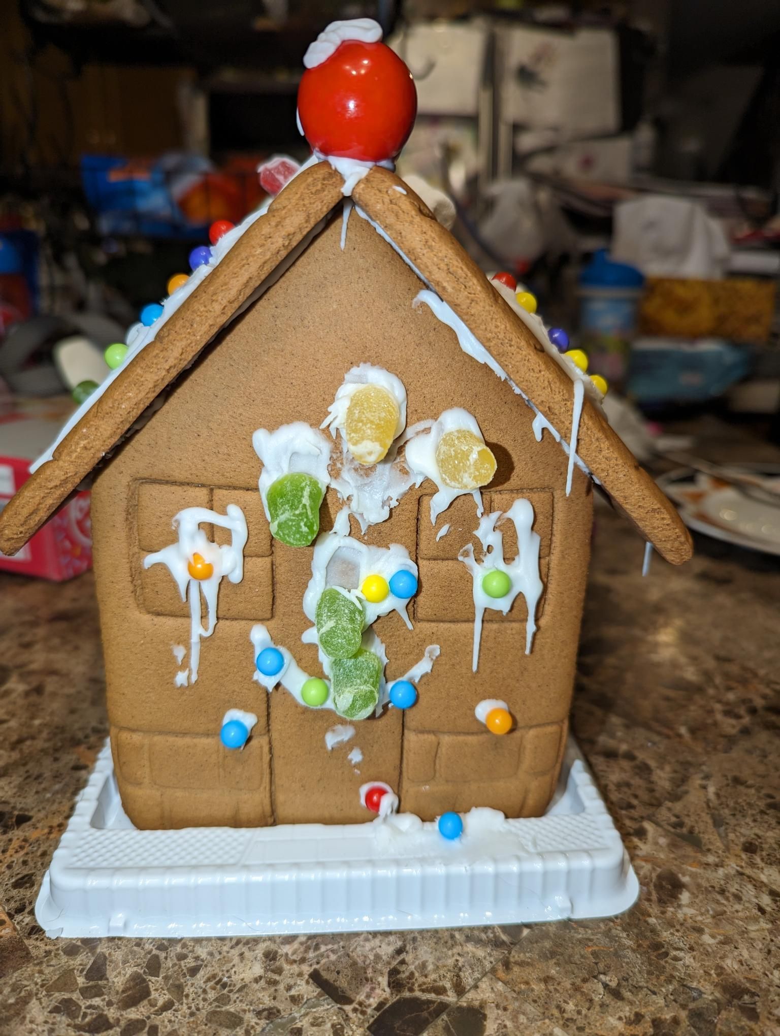A gingerbread house is sitting on top of a counter.