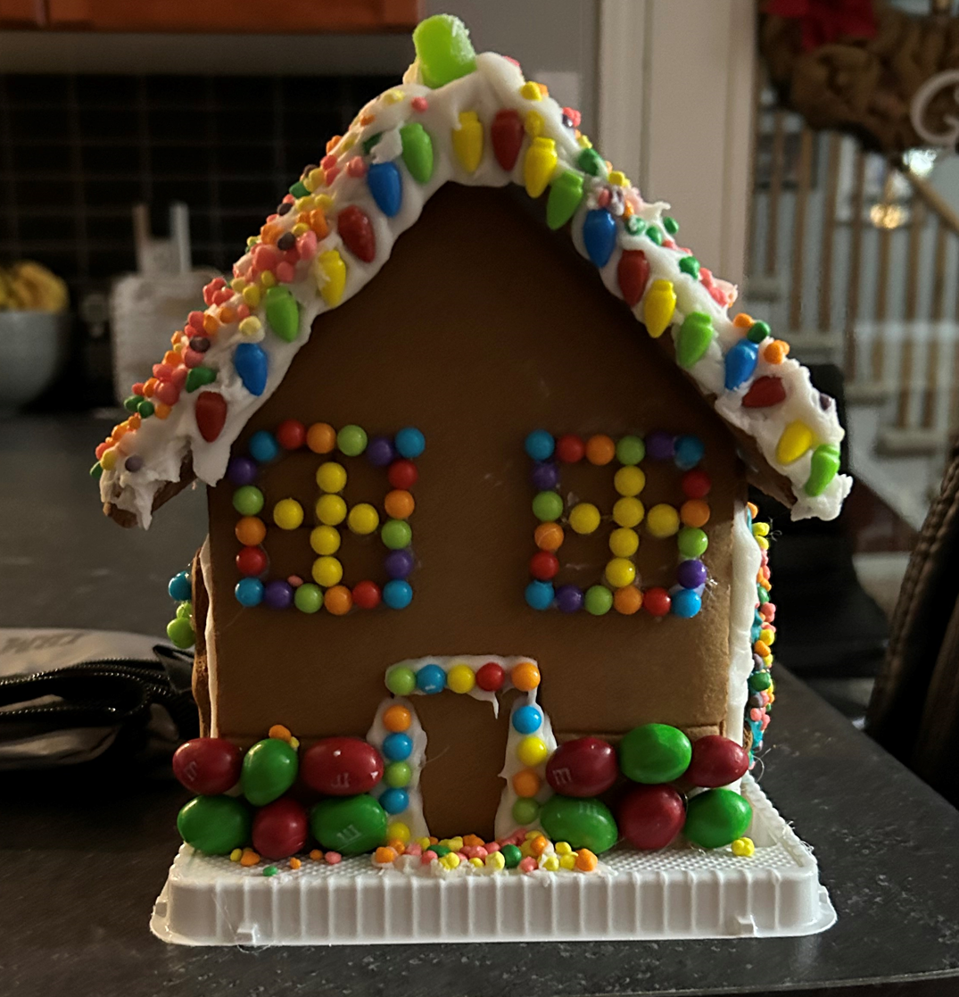 A gingerbread house decorated with sprinkles and icing