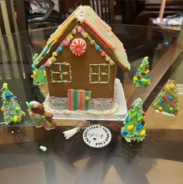 A gingerbread house sitting on top of a glass table