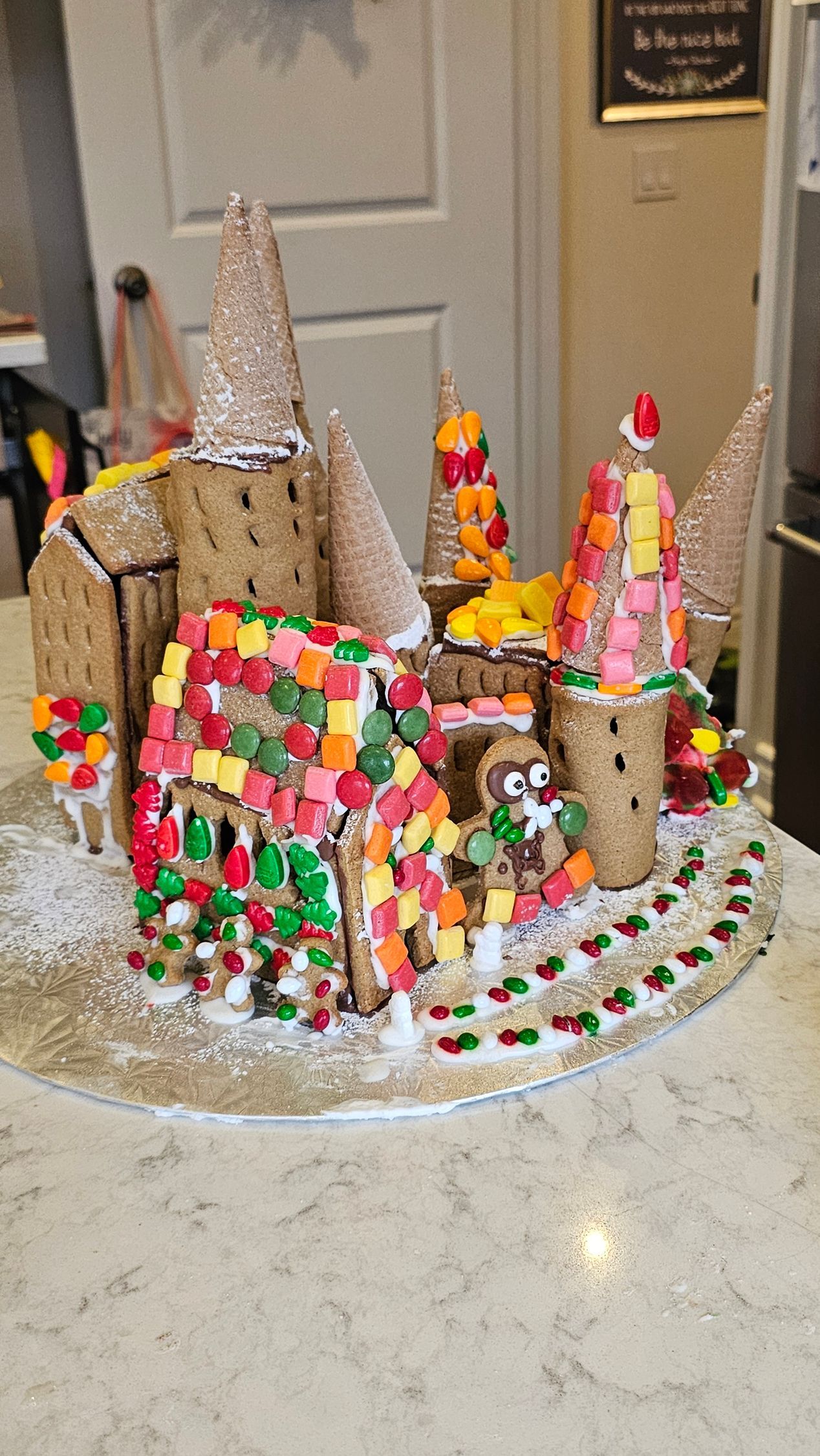 A gingerbread castle is sitting on top of a counter.