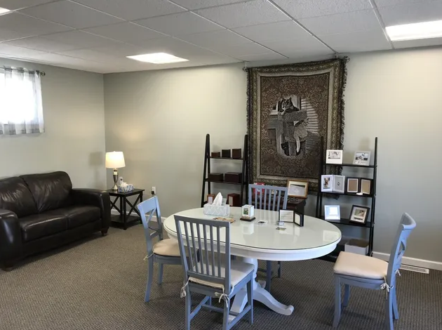 A living room with a table and chairs and a couch.