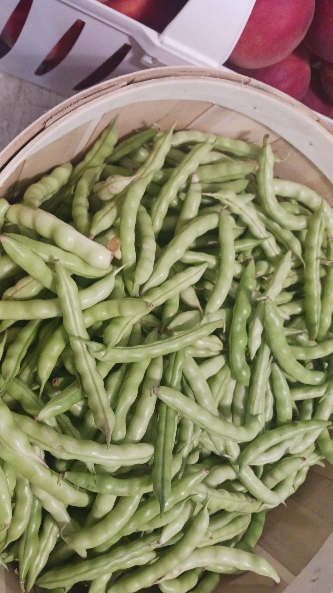 Green beans in a wicker basket.