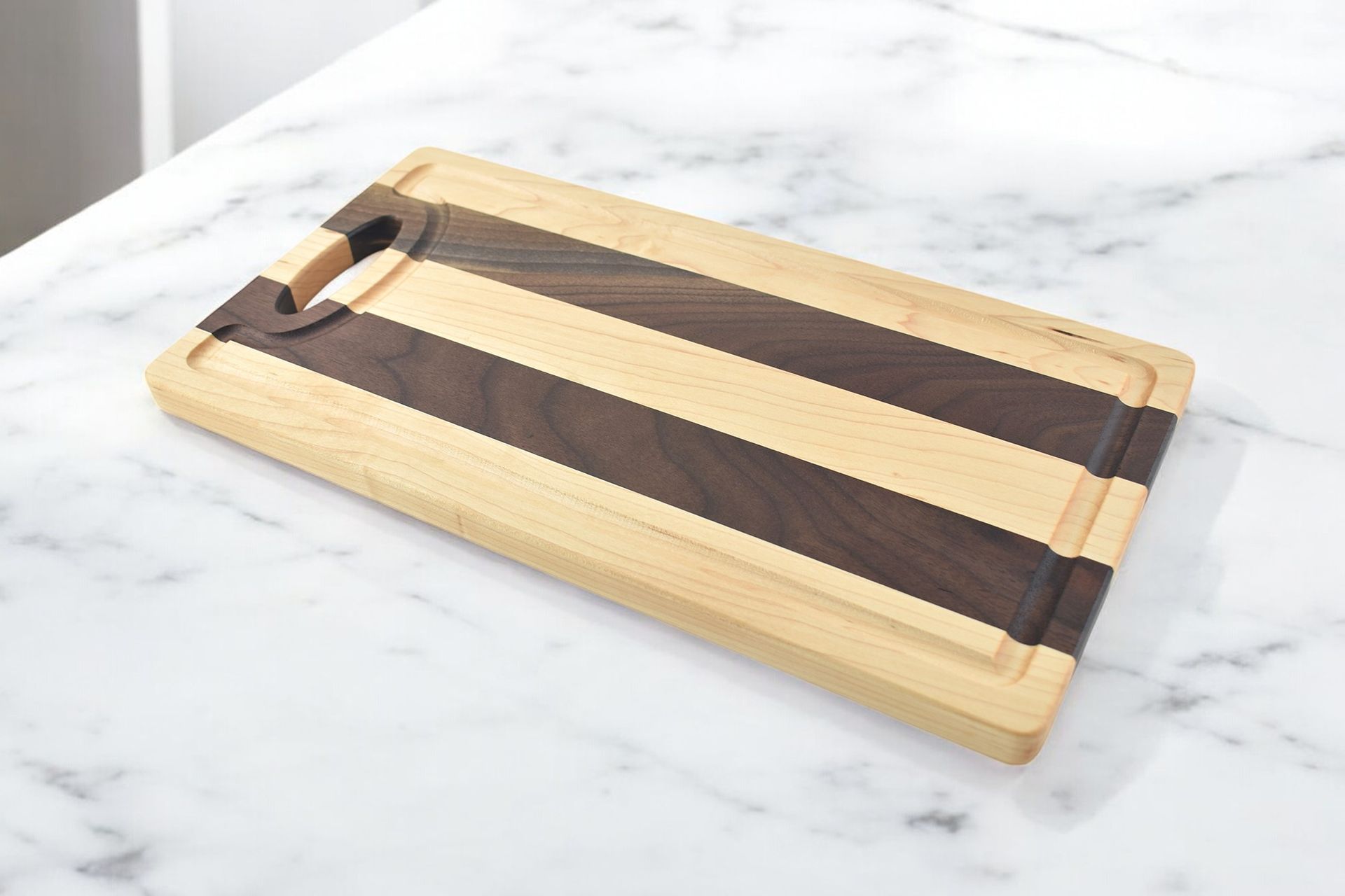 A wooden cutting board is sitting on a marble counter top