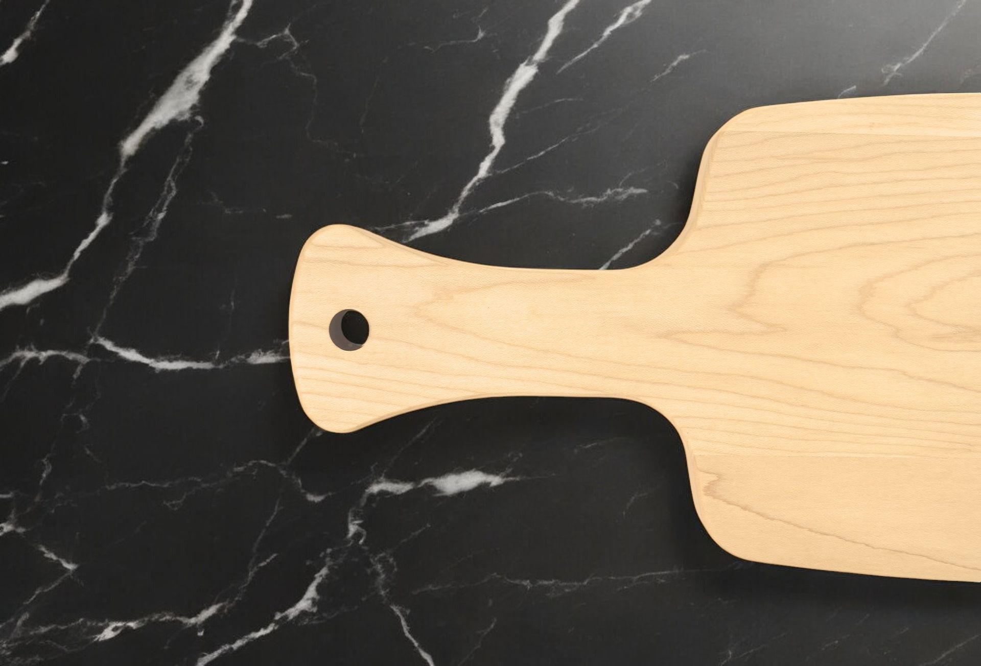 A wooden cutting board is sitting on a black marble counter top