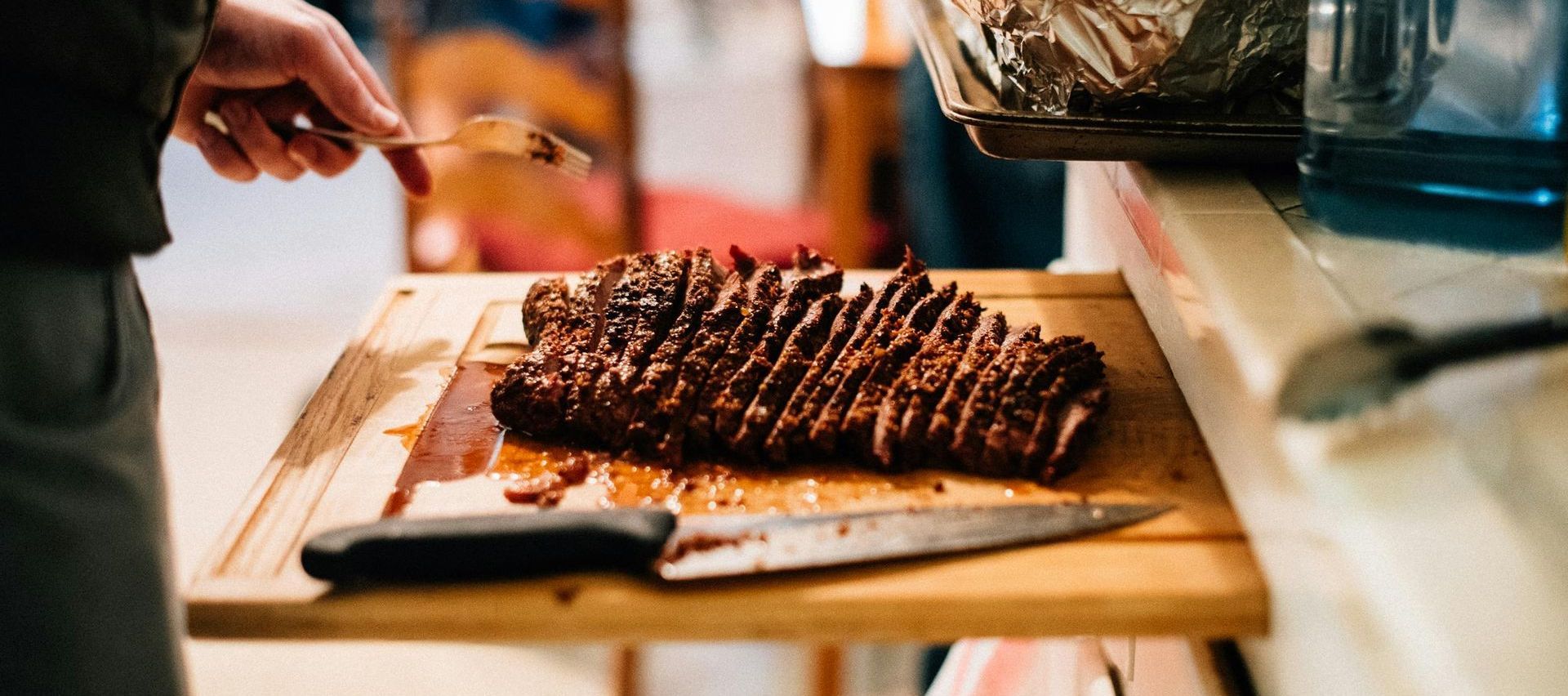 BBQ meat on a wooden cutting board.