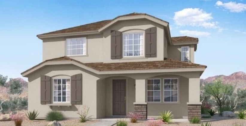Two-story house with beige stucco exterior, brown shutters, and a front porch in a desert setting.