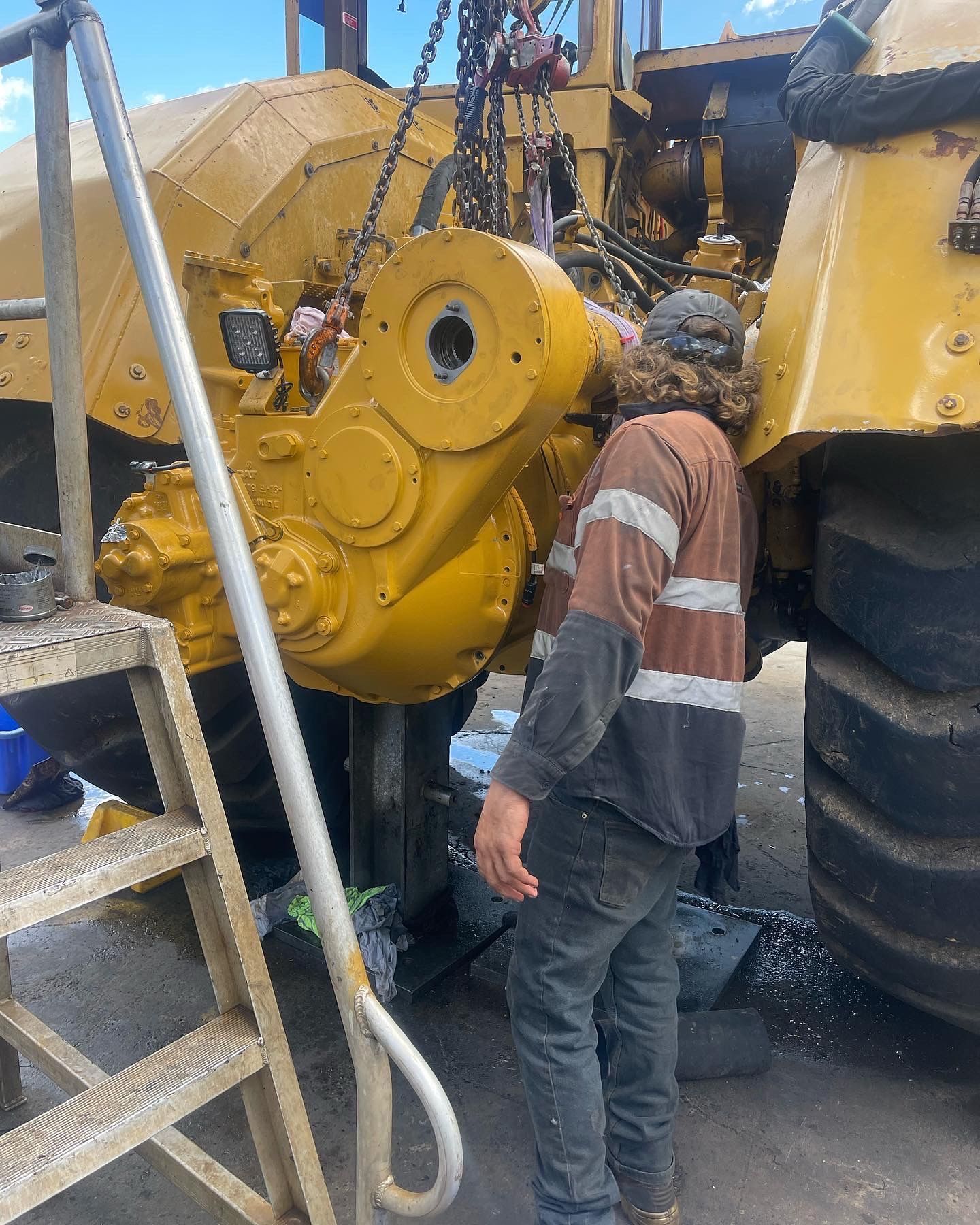 Mechanic Working on Yellow Heavy Machinery, Using a Ladder — HOLESHOT Diesel In Gympie, QLD