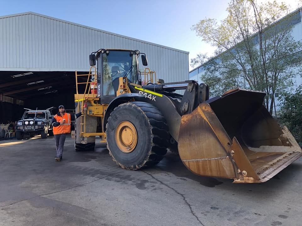 Yellow Front-end Loader Parked Near a Warehouse — HOLESHOT Diesel In Kingaroy, QLD