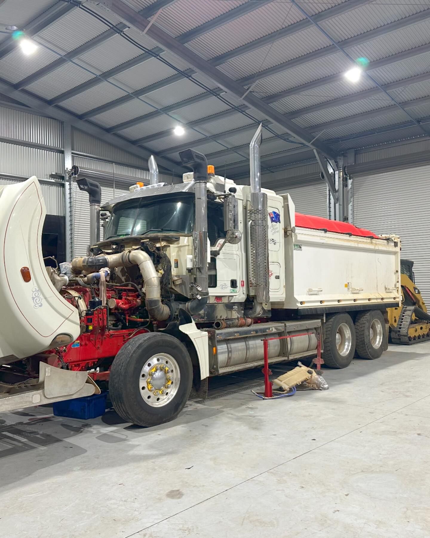 White Dump Truck in a Repair Shop With the Hood Open — HOLESHOT Diesel In Gympie, QLD