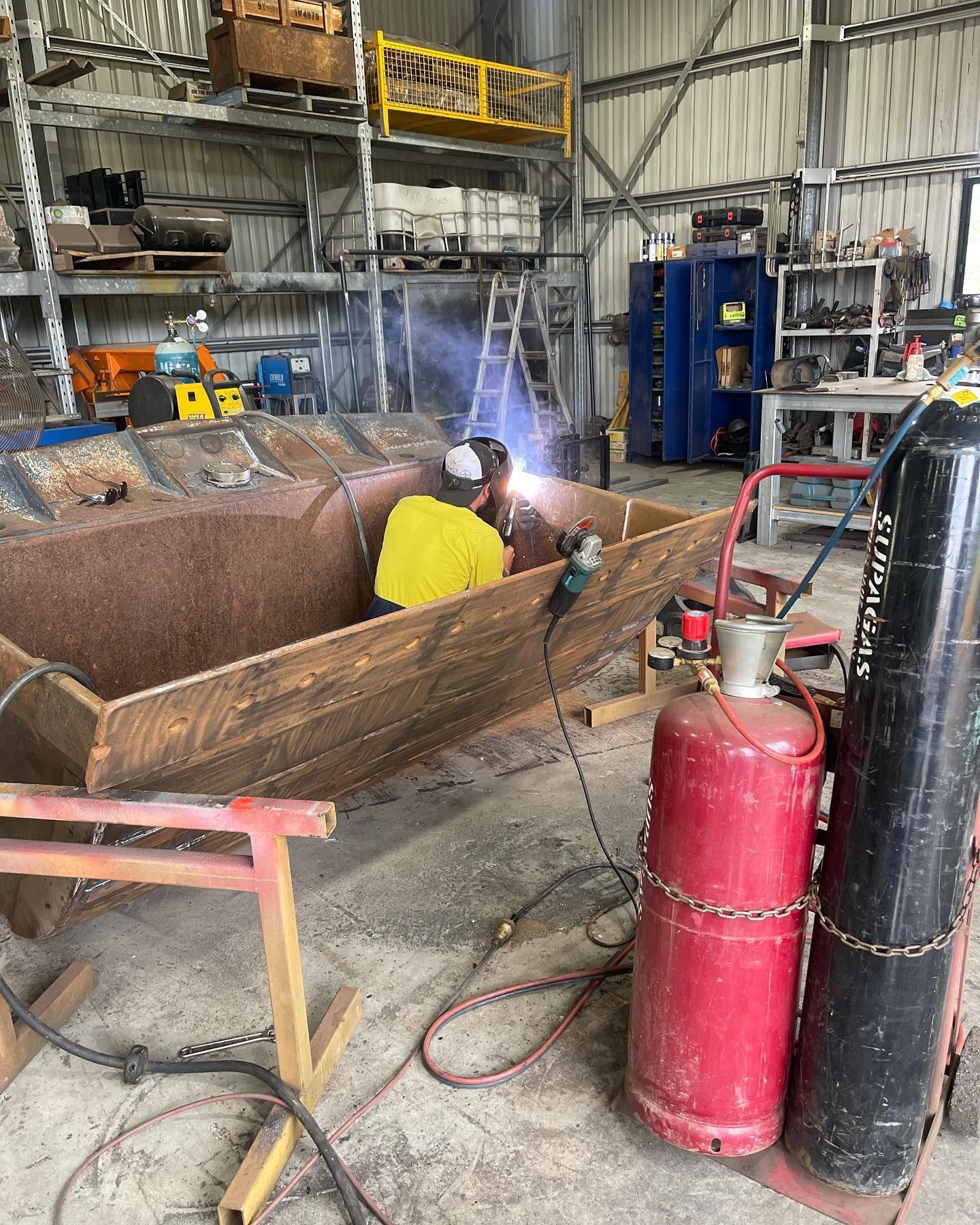 A Person Welding Inside a Large Metal Structure in a Workshop — HOLESHOT Diesel In Maryborough, QLD