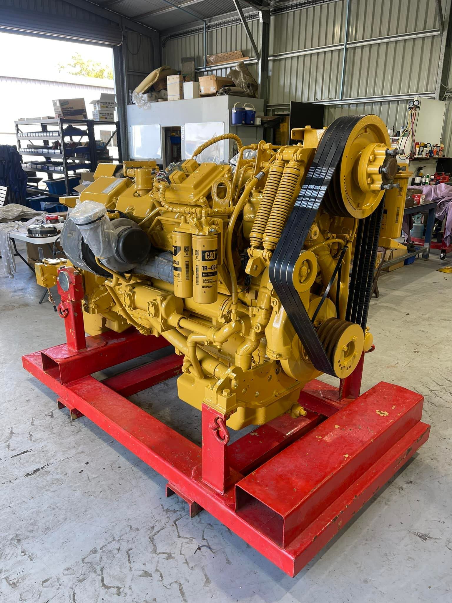 Yellow Caterpillar Engine on a Red Metal Stand in a Workshop — HOLESHOT Diesel In Gympie, QLD