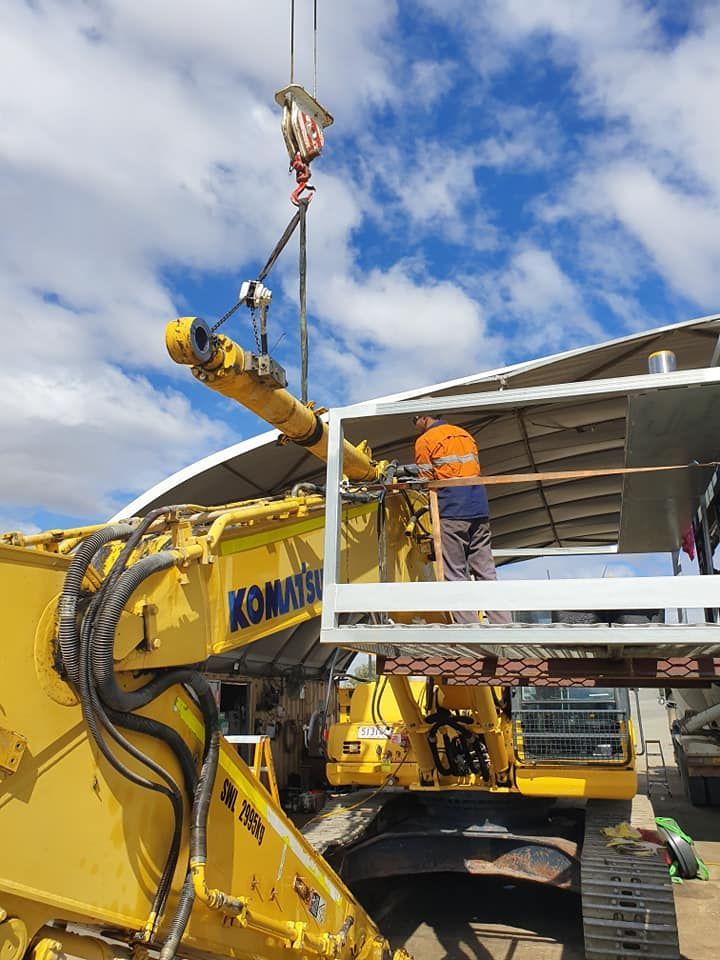 A Yellow Excavator With a Person Working on Attaching a Metal Frame — HOLESHOT Diesel In Maryborough, QLD