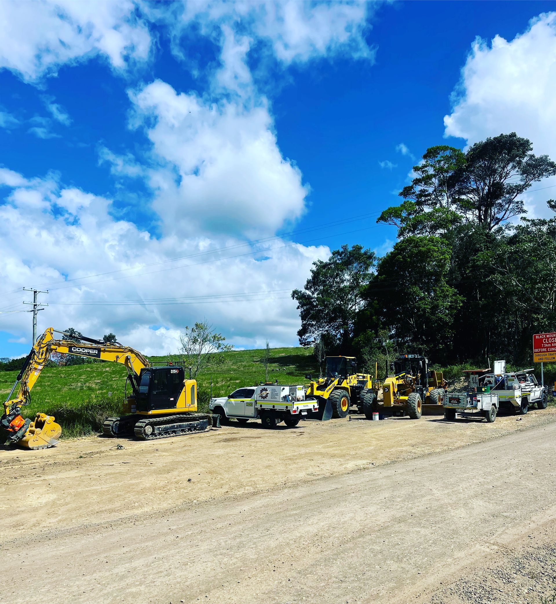 Construction Equipment and Vehicles Parked on a Dirt Lot With a Blue Sky — HOLESHOT Diesel In Chinchilla, QLD