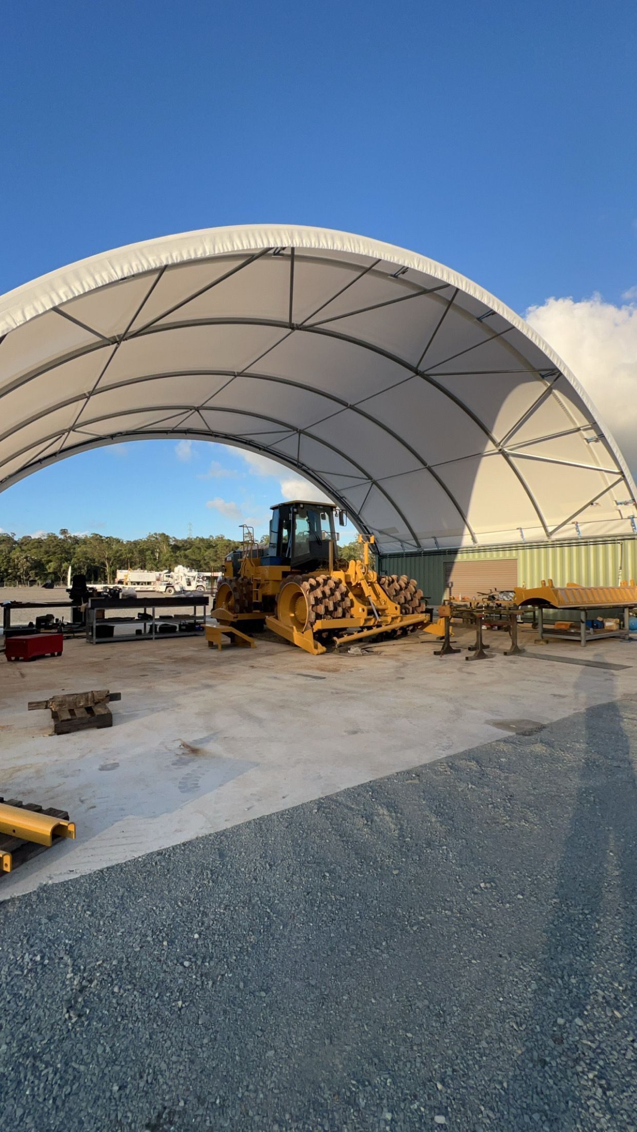 Yellow Bulldozer Under a White Arched Shelter — HOLESHOT Diesel In Maryborough, QLD