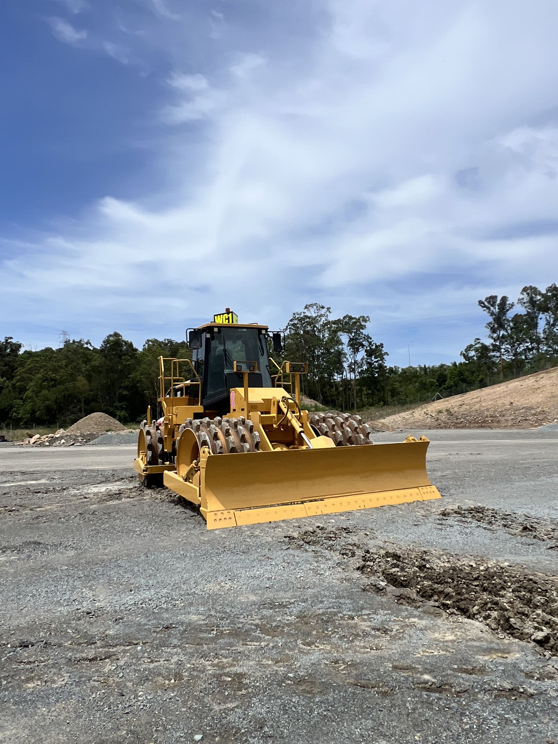 Yellow Bulldozer With Blade, on Gravel, Against a Backdrop of Trees — HOLESHOT Diesel In Gympie, QLD