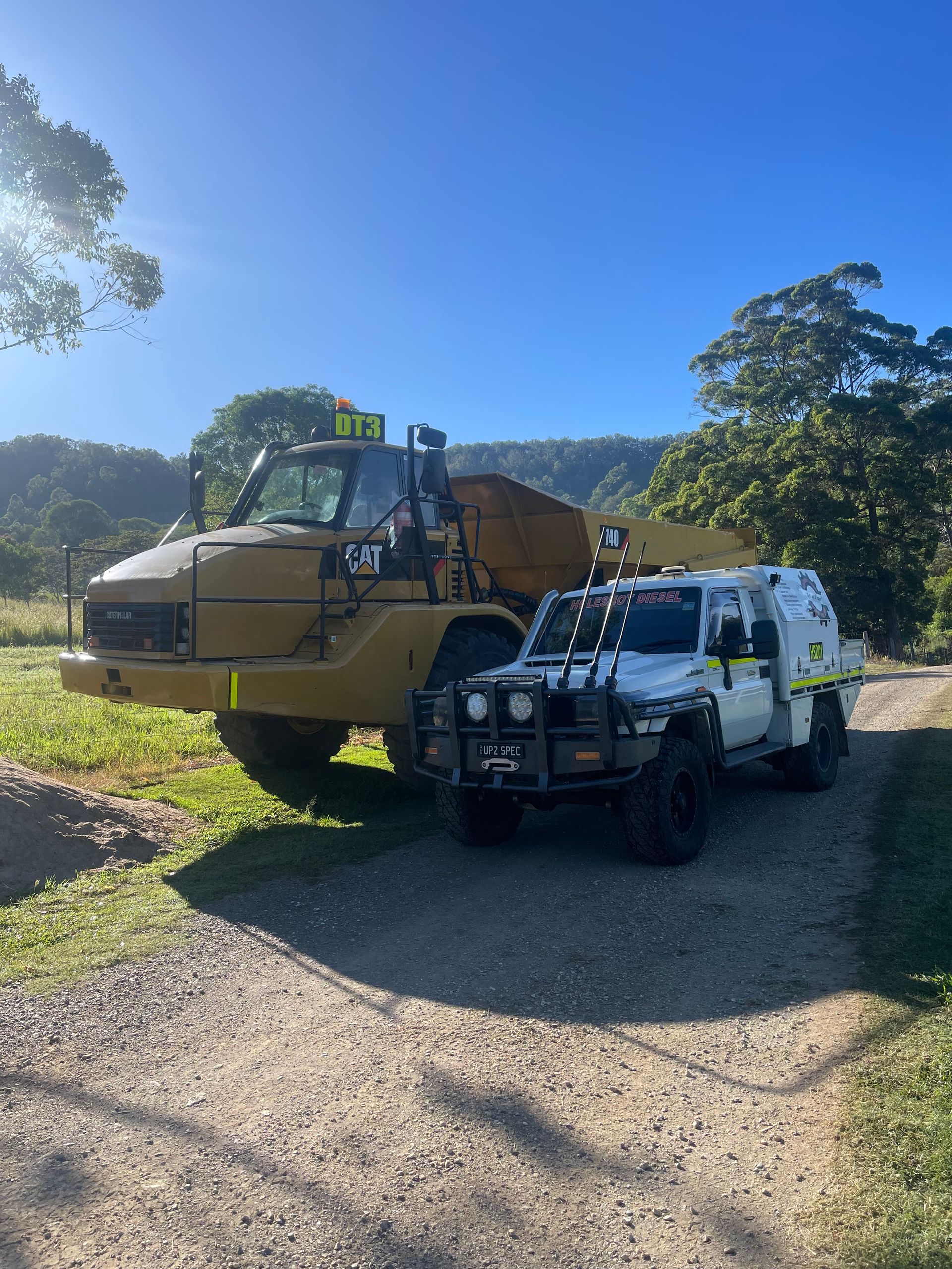 A Large Yellow Caterpillar Dump Truck Parked — HOLESHOT Diesel In Maryborough, QLD