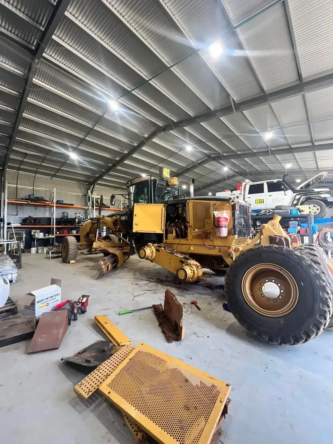 Yellow Grader Machine in a Repair Bay, Partially Disassembled — HOLESHOT Diesel In Kingaroy, QLD