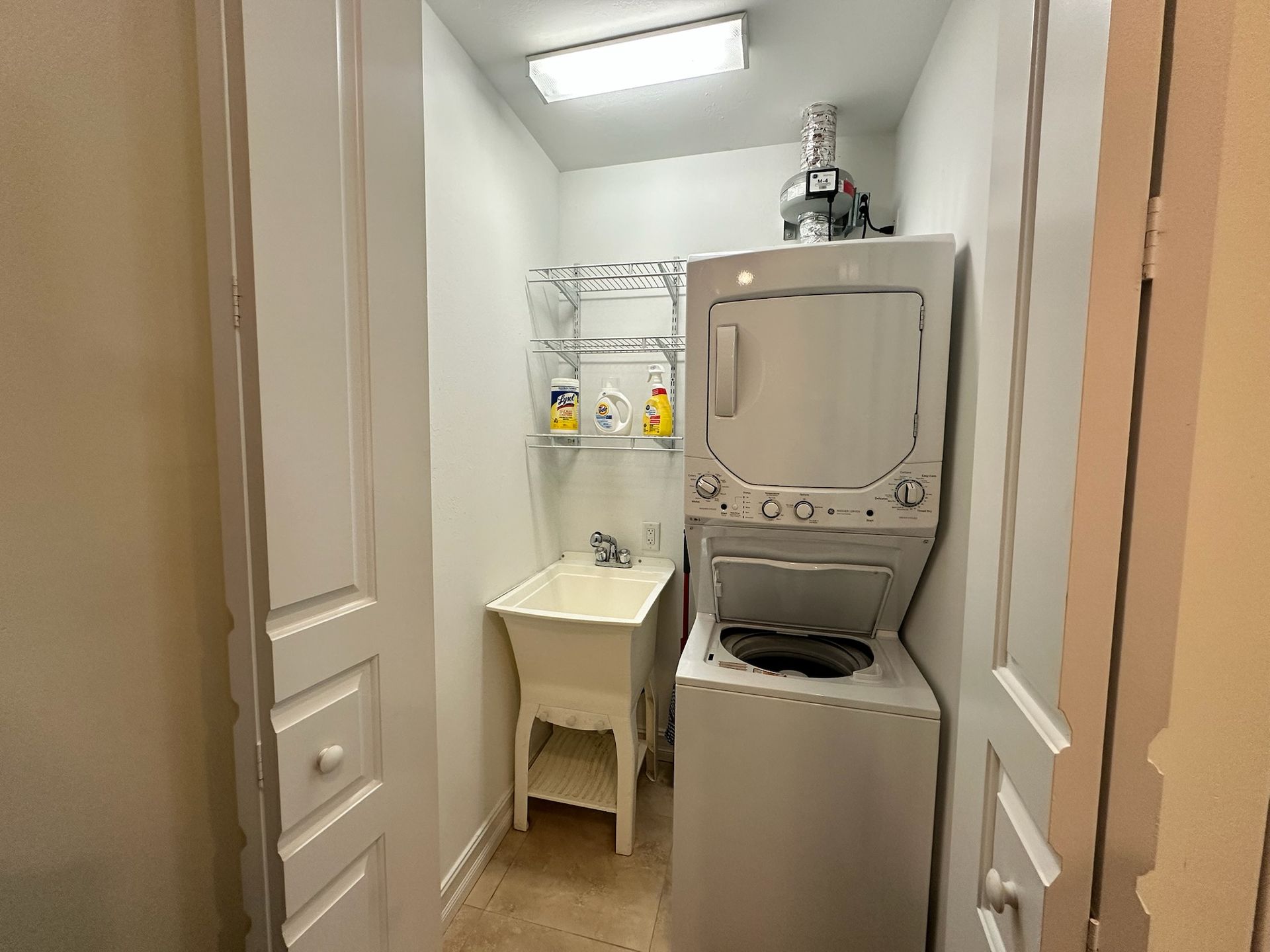A laundry room with a washer and dryer and a sink.