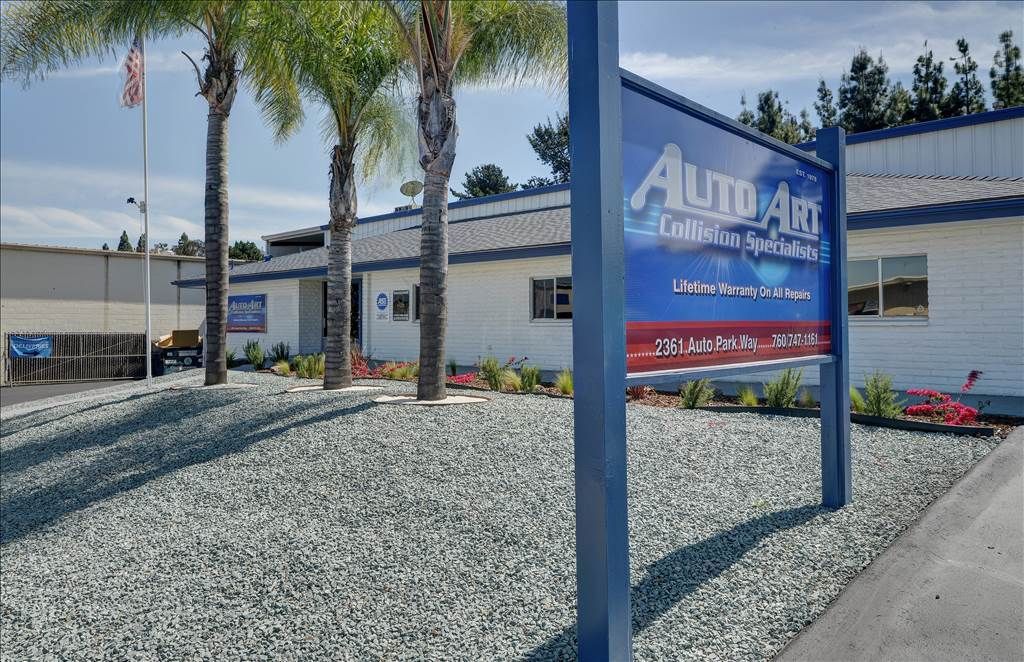 A building with a sign in front of it that says auto air