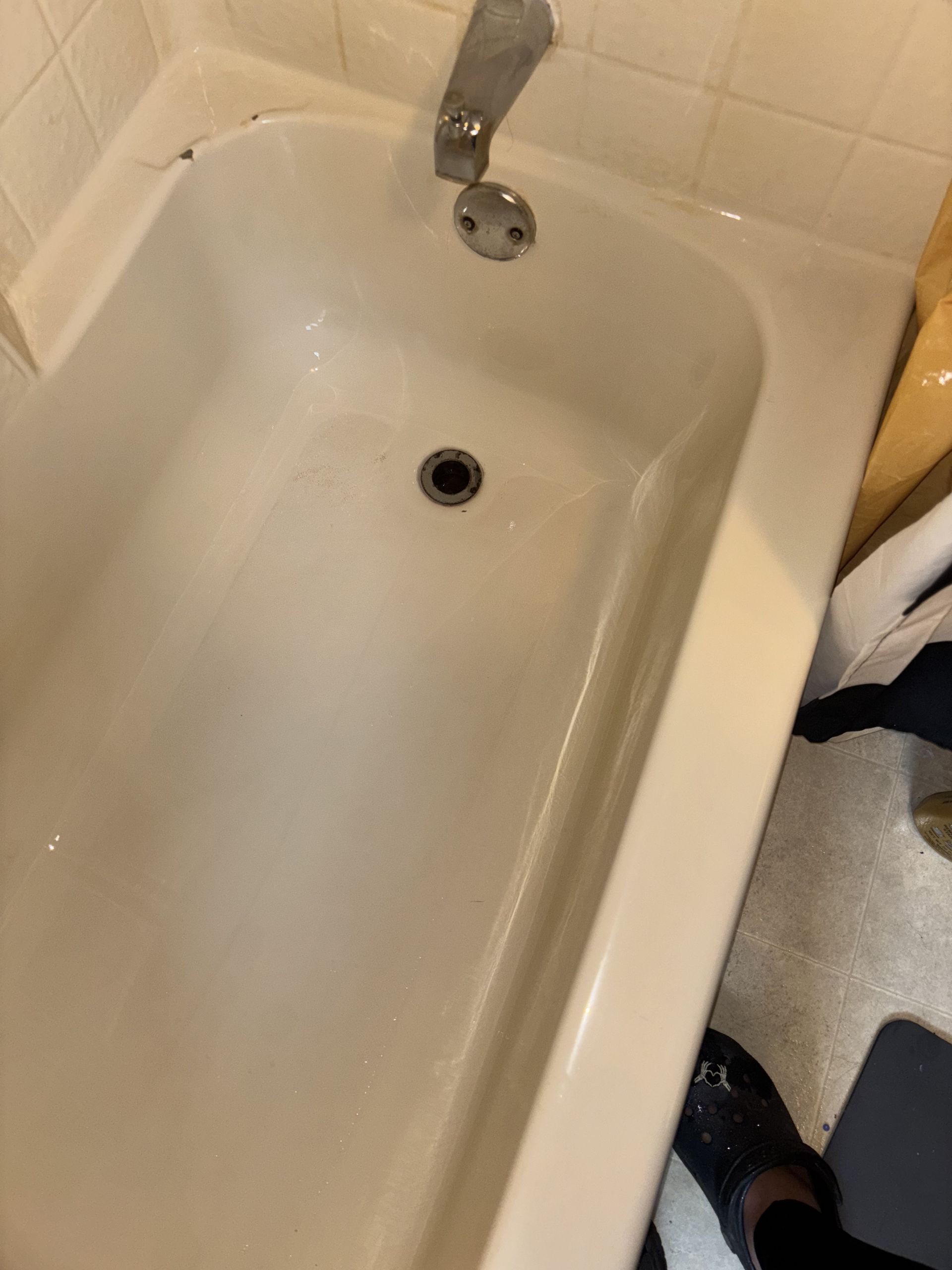 White bathtub with faucet, viewed from above.