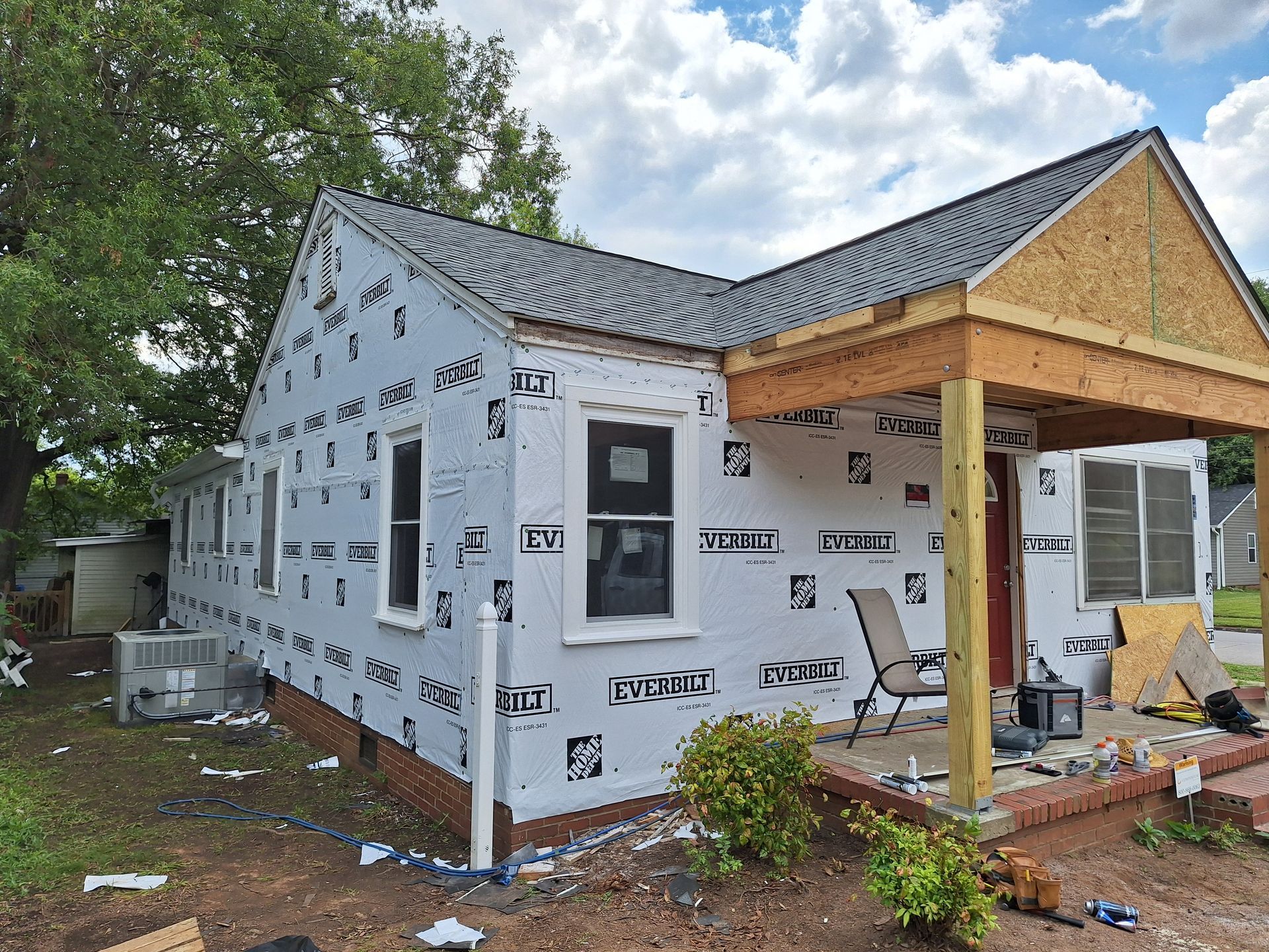 A house is being remodeled with a porch and a roof.