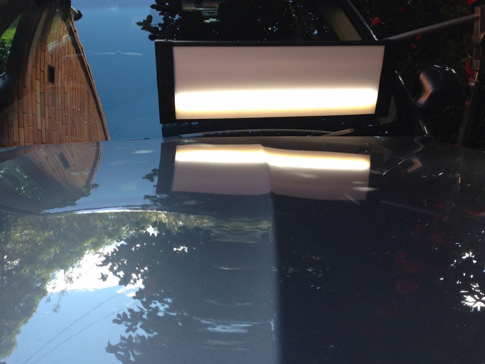 A Reflection of a House in the Windshield of a Car — Rapid Auto Dent In Avoca Beach, NSW