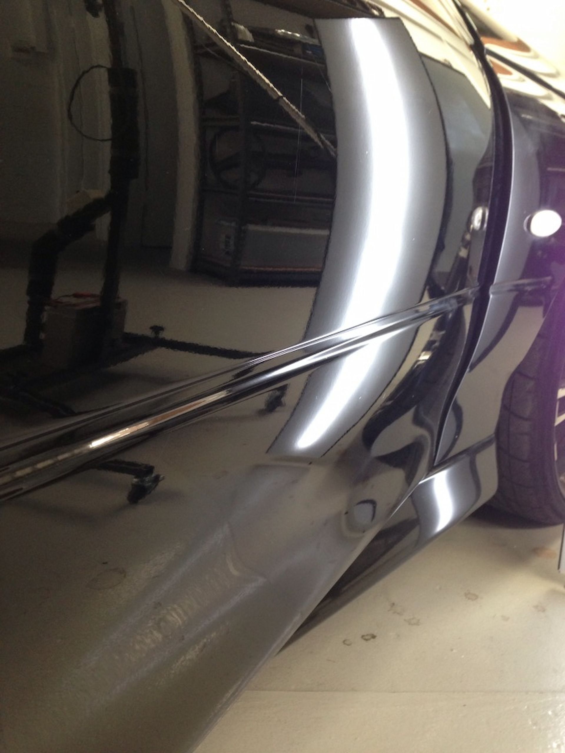 A Silver Car is Parked in a Garage With the Door Open — Rapid Auto Dent In Umina, NSW