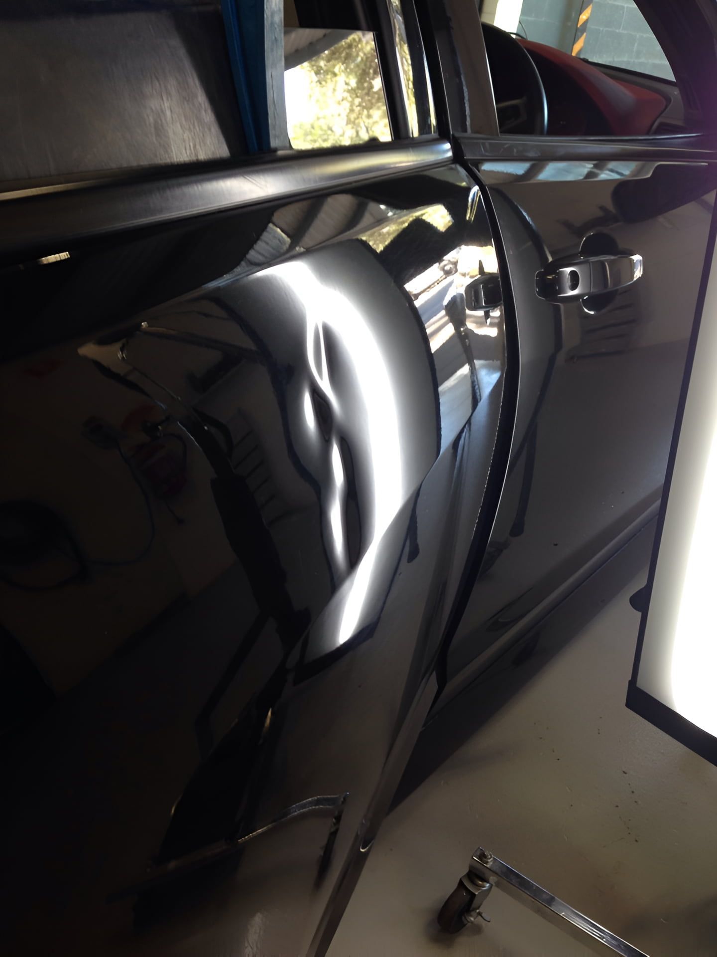 A Black Car With a Dent in the Door — Rapid Auto Dent In Woy Woy, NSW