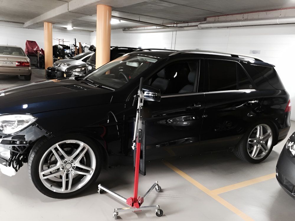 A Black Suv Is Parked In A Parking Garage — Rapid Auto Dent In West Gosford, NSW