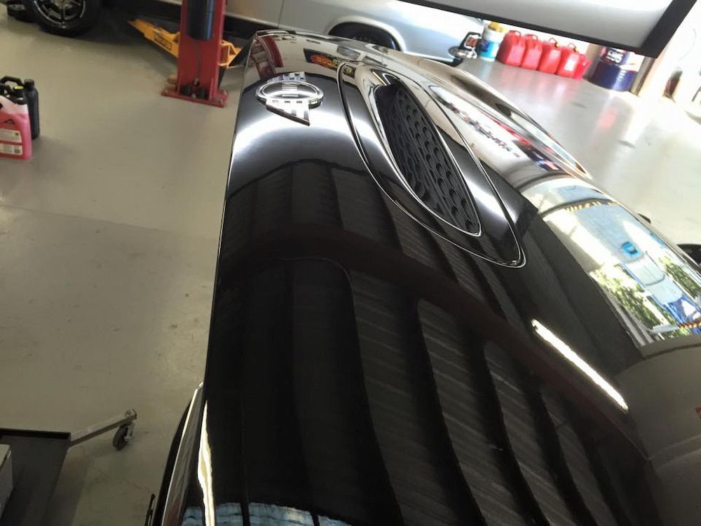A Black Car With A Nissan Logo On The Hood — Rapid Auto Dent In West Gosford, NSW