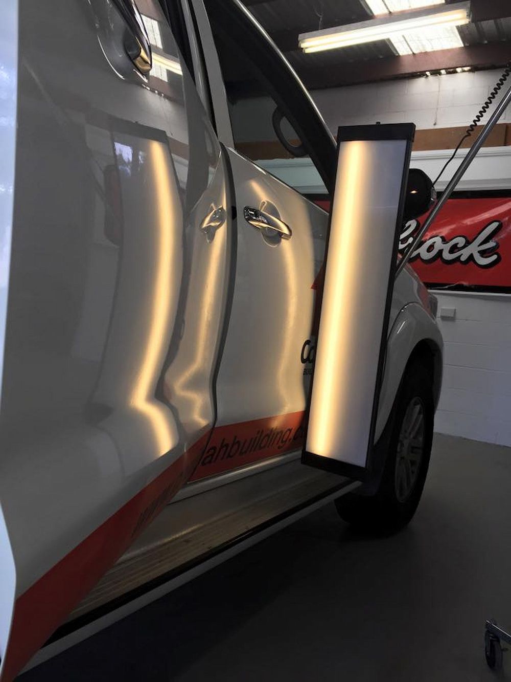 A Car With A Dent In The Door Is In A Garage — Rapid Auto Dent In West Gosford, NSW