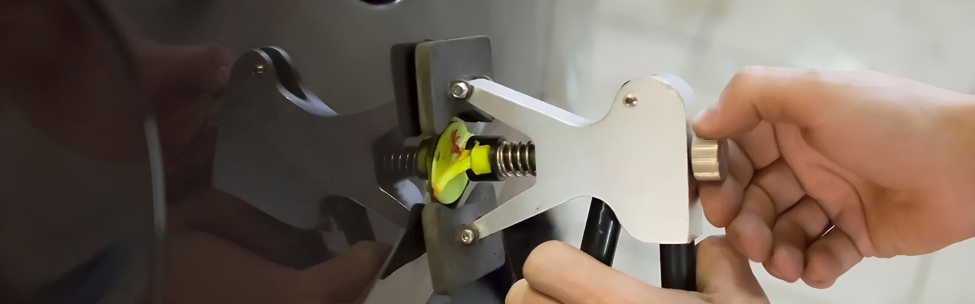 A Person Is Using A Tool To Remove A Dent From A Car — Rapid Auto Dent In West Gosford, NSW