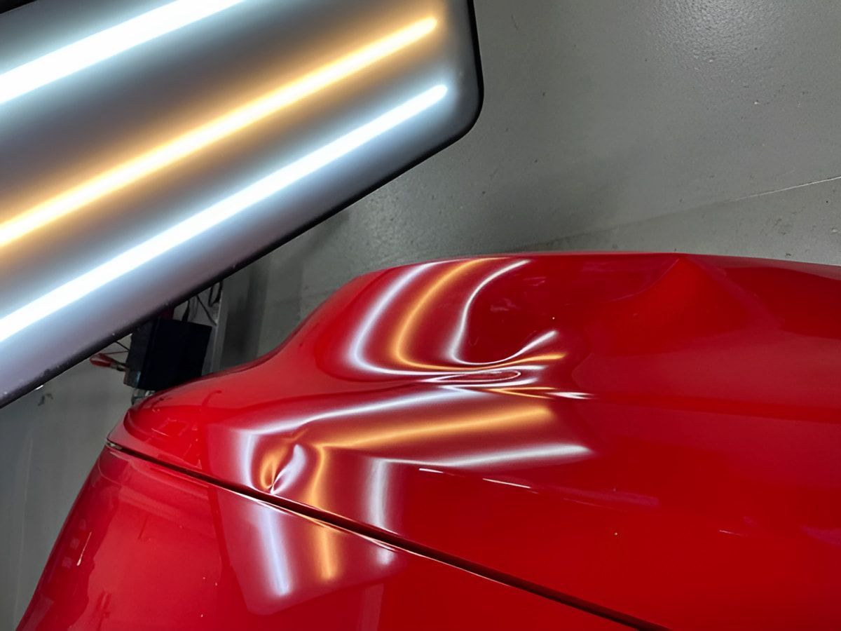 A Close Up of a Red Car With a Light on It — Rapid Auto Dent In Budgewoi, NSW