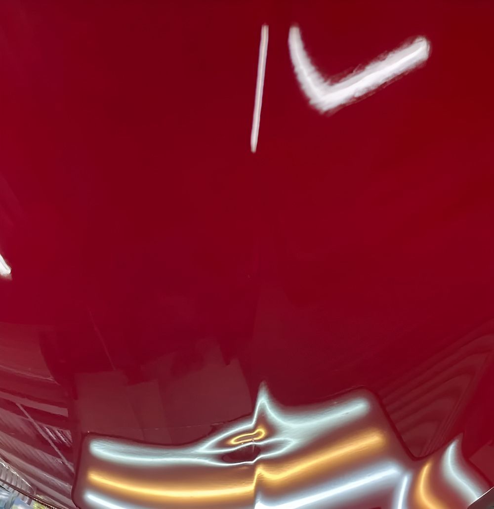 A Close Up of a Red Car's Hood With a Few White Lines on It — Rapid Auto Dent In Woy Woy, NSW